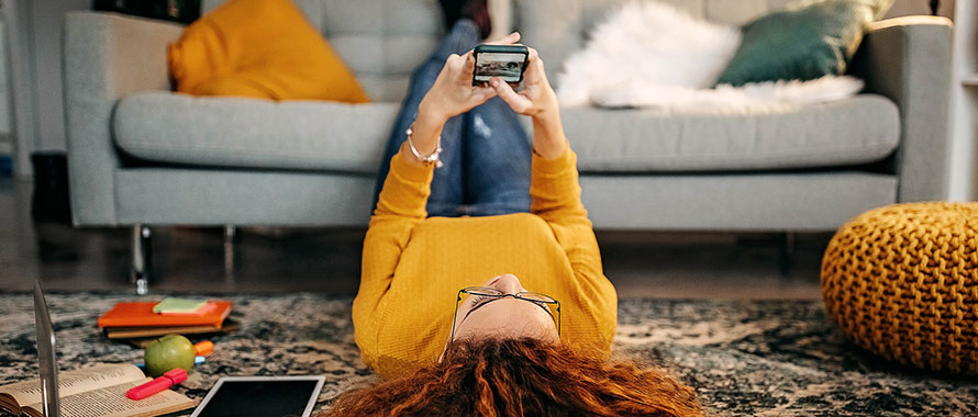 woman on the floor looking at phone