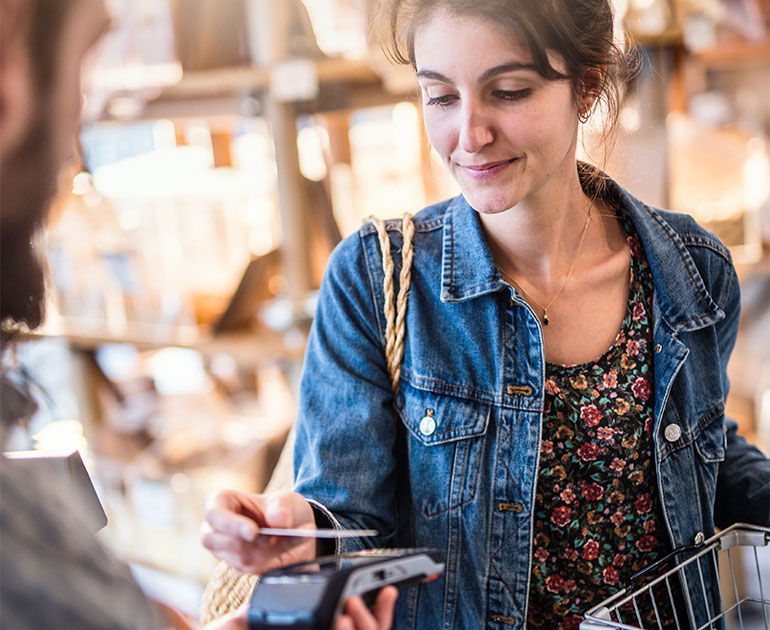 woman making purchase with credit card in shop