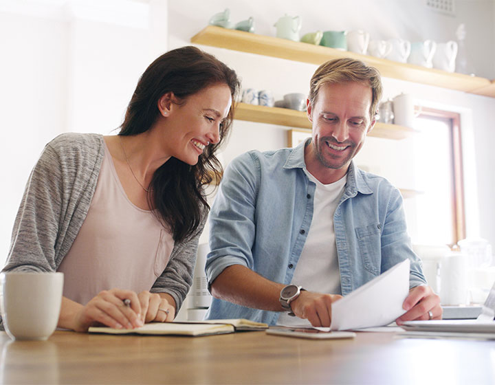 Couple reviewing finances in kitchen