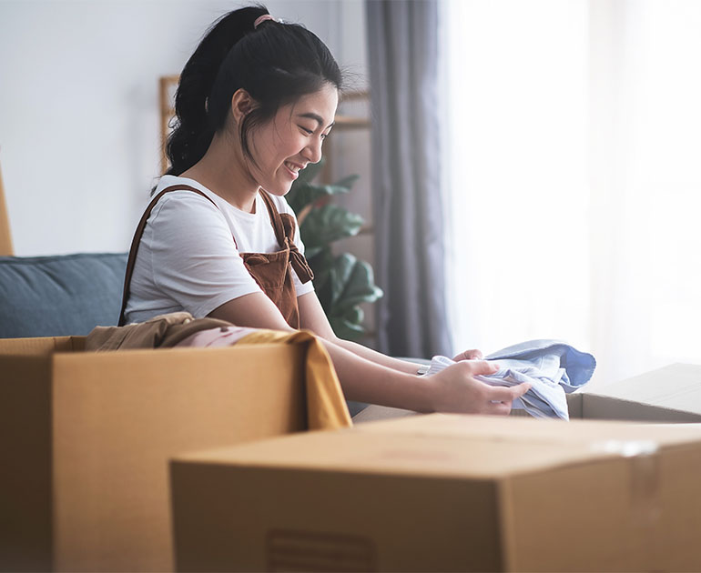 woman unpacking boxes in home