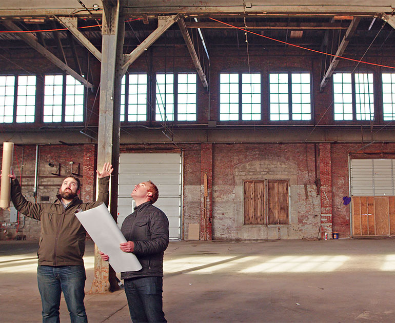 men planning inside empty warehouse
