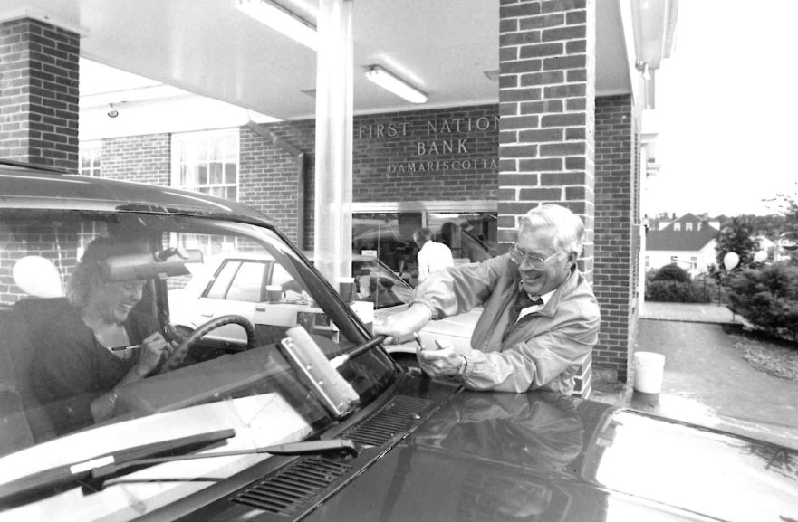 Historic photo of FNB employees washing windshields for customers on customer appreciation day